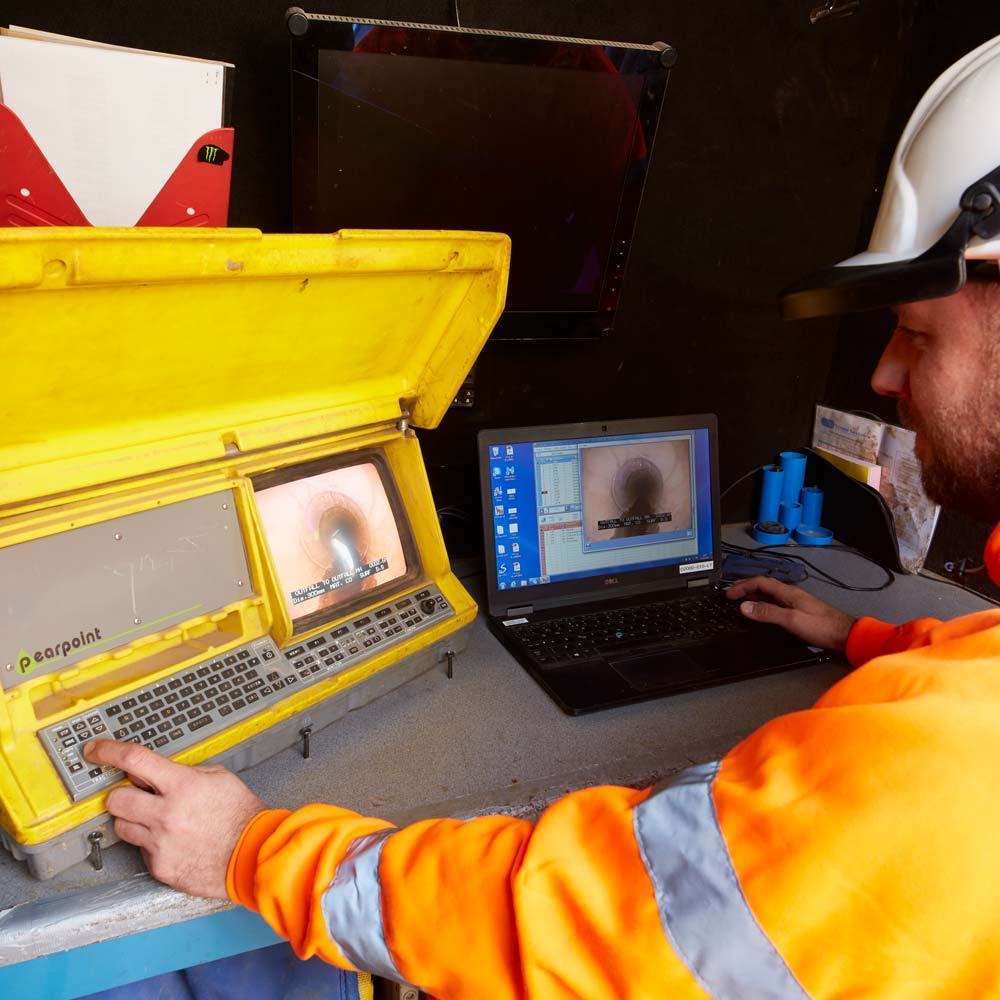 Engineer reviewing CCTV drain footage