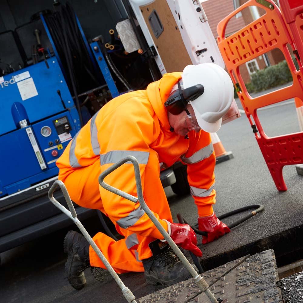 Engineer clearing a blocked drain